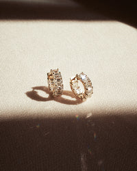 The Luv Aj Fine Emerald Prong Set Huggies on white background View 3