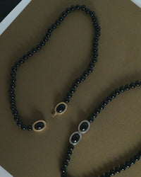The Luv Aj Midnight Mesa Beaded Necklace in Gold and Silver on Green background View 3