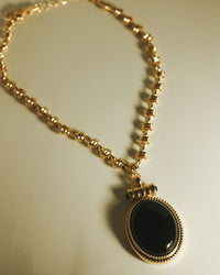 The Luv Aj Midnight Mesa Pendant Necklace in Gold laying flat on background View 3
