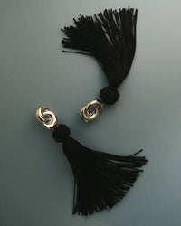 The Luv Aj Solstice Knot Tassel Earrings in Gold on grey background View 2