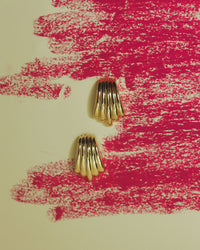 The Luv Aj Sundown Statement Studs in Gold with artsy background View 2