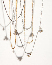 The Bella Diamond Charm Necklace are the two necklaces on the left View 11