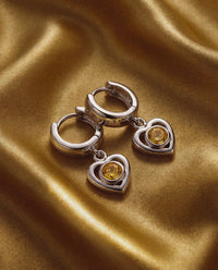 Luv Aj Charlotte Citrine Heart Hoops in Silver, flat lay View 3