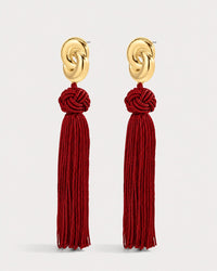Luv Aj The Solstice Knot Tassel Earrings in Ruby, Gold on grey background View 1