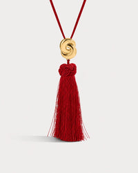 Luv Aj The Solstice Knot Tassel Necklace in Ruby, Gold on grey background View 1